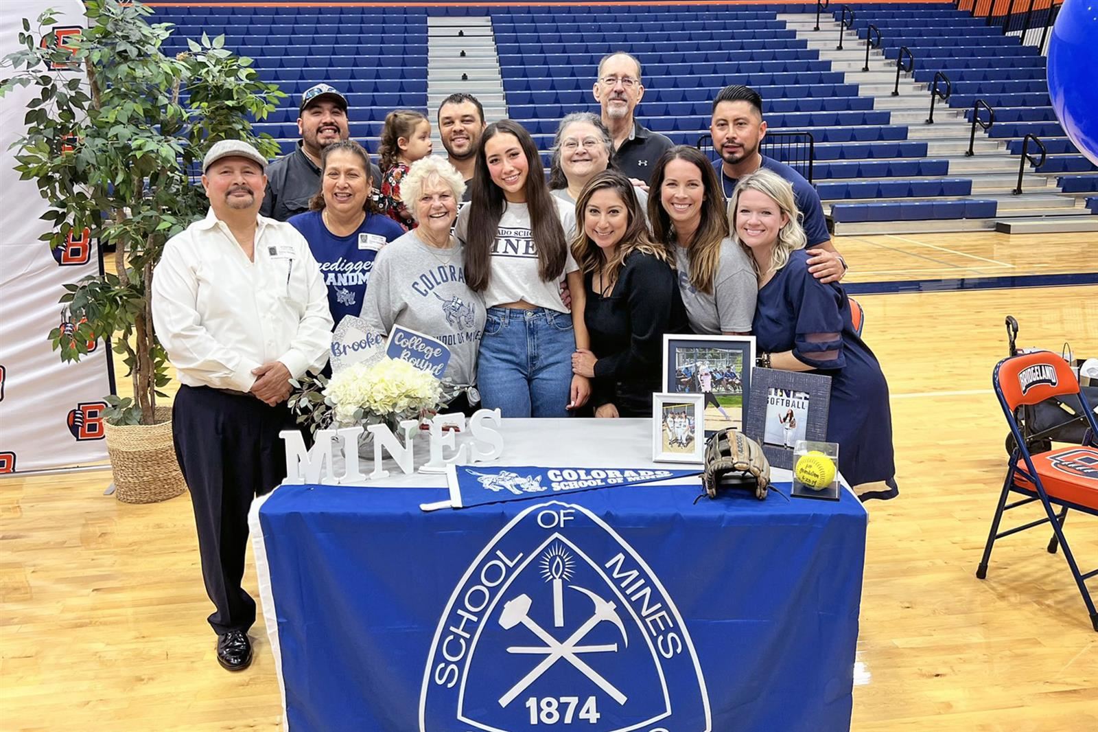 Bridgeland High School senior Brooke Gonzales, center, poses with family after signing a letter of intent to play softball.